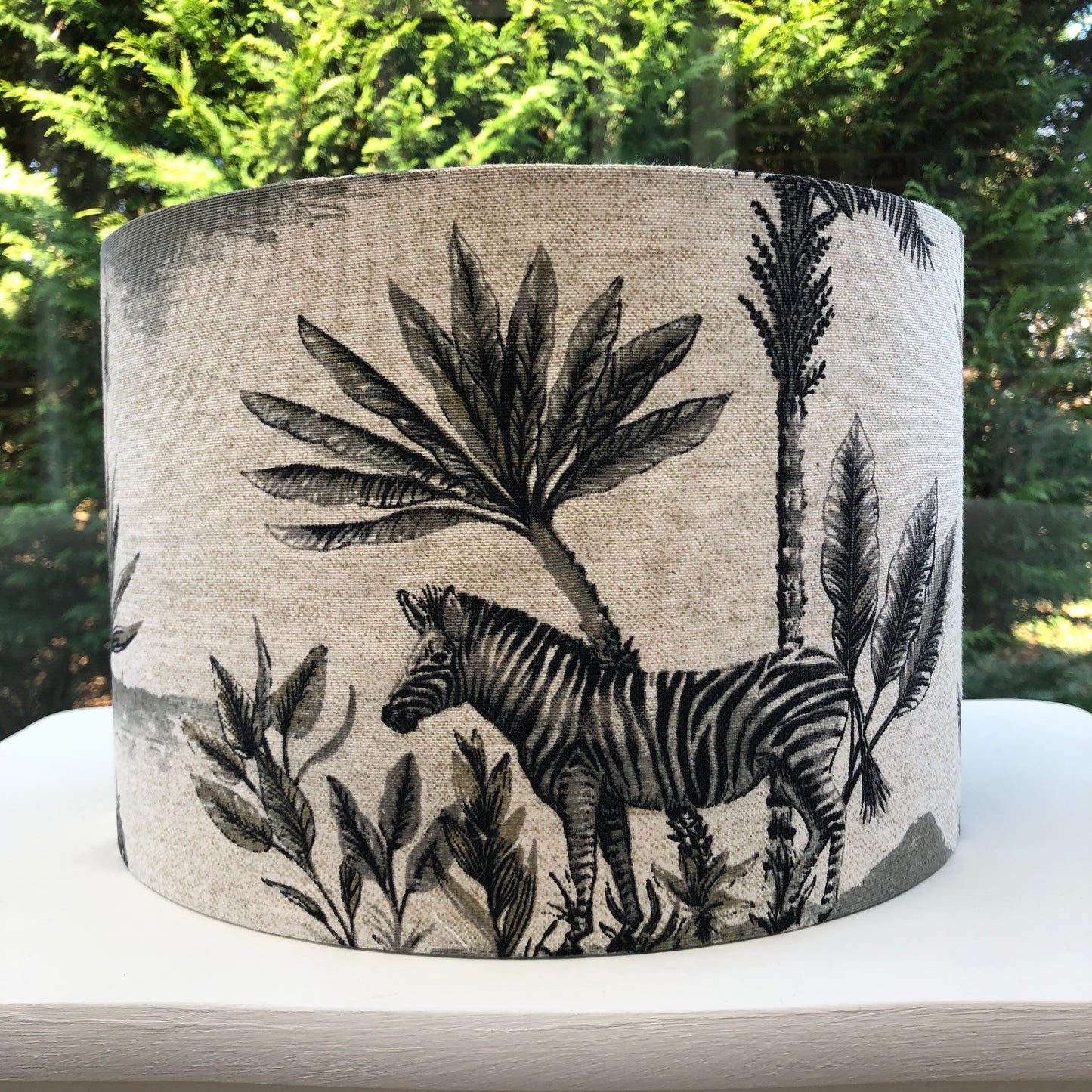 African safari-themed lampshade with vibrant animal and landscape motifs, perfect for adding a touch of exotic style and warmth to home decor.