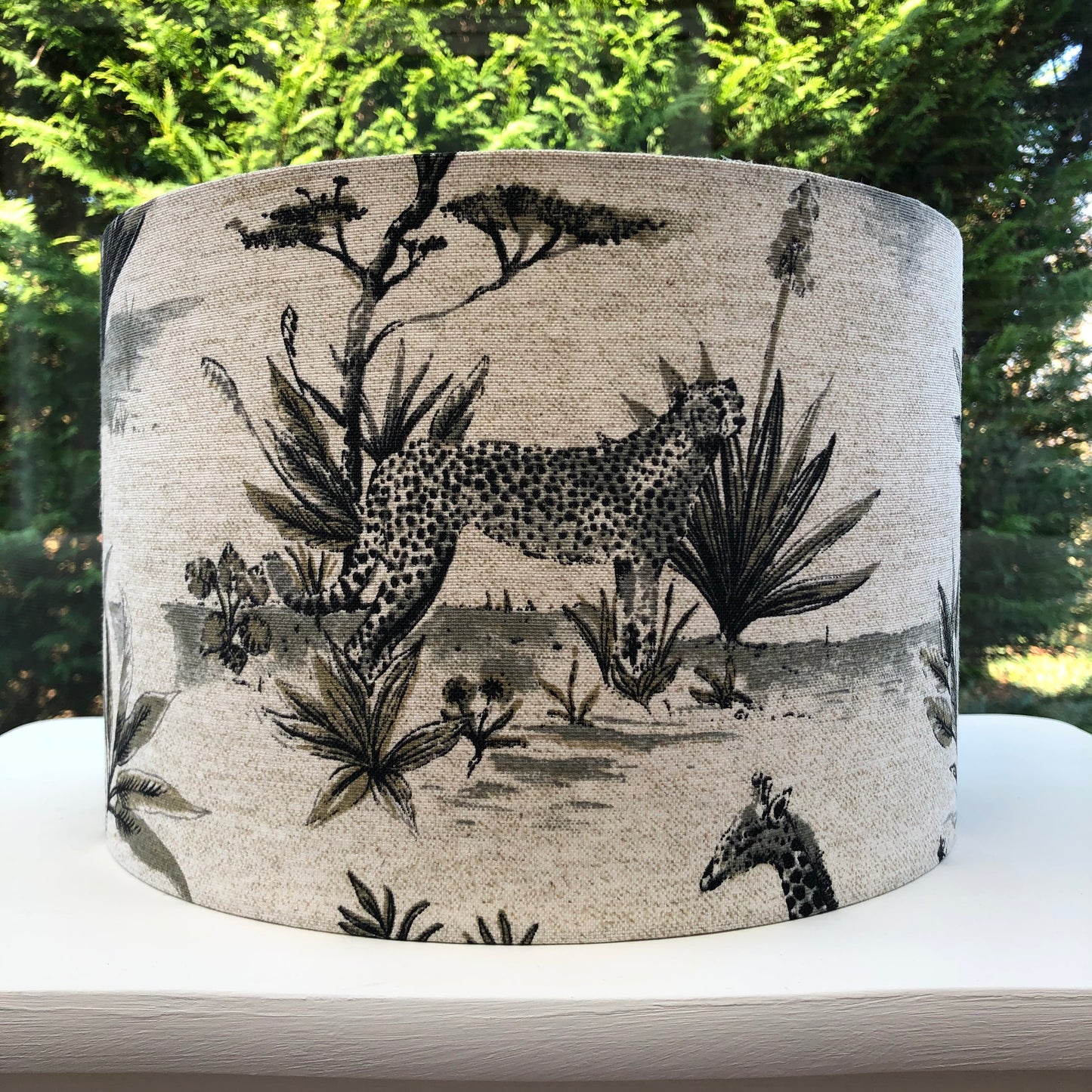 African safari-themed lampshade with vibrant animal and landscape motifs, perfect for adding a touch of exotic style and warmth to home decor.