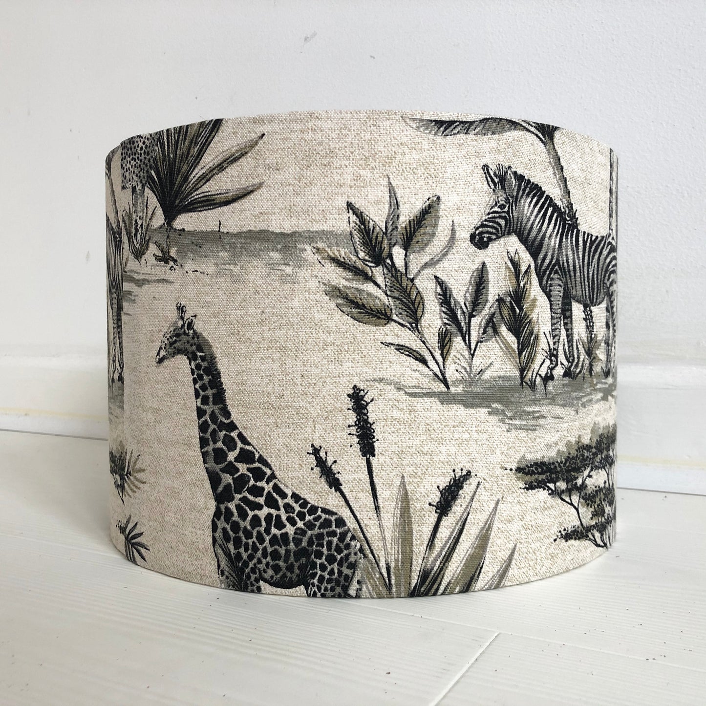African safari-themed lampshade with vibrant animal and landscape motifs, perfect for adding a touch of exotic style and warmth to home decor.