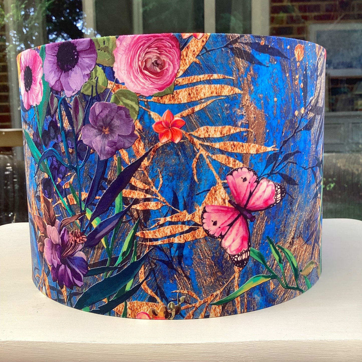 A luxurious blue velvet lampshade with a soft, plush texture and a warm, inviting glow, adding a touch of sophistication to any room.
