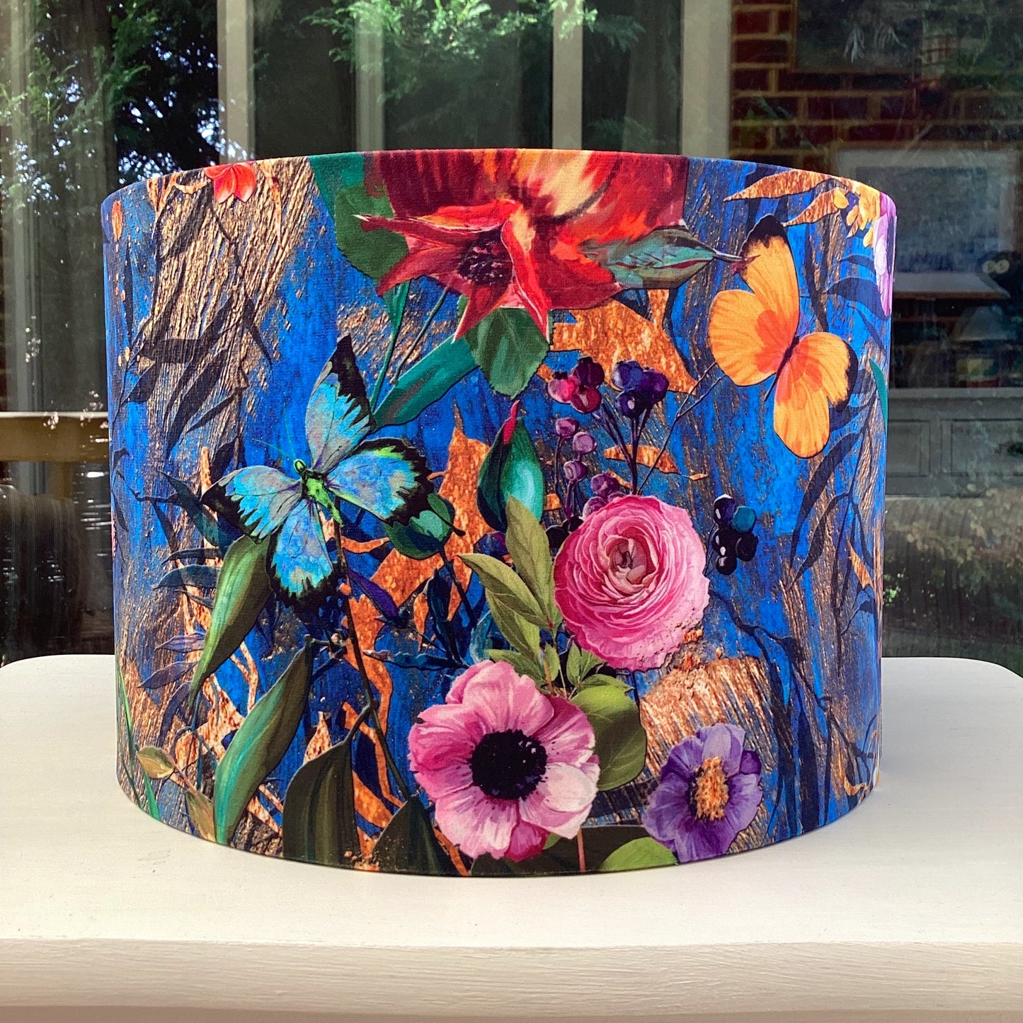 A luxurious blue velvet lampshade with a soft, plush texture and a warm, inviting glow, adding a touch of sophistication to any room.