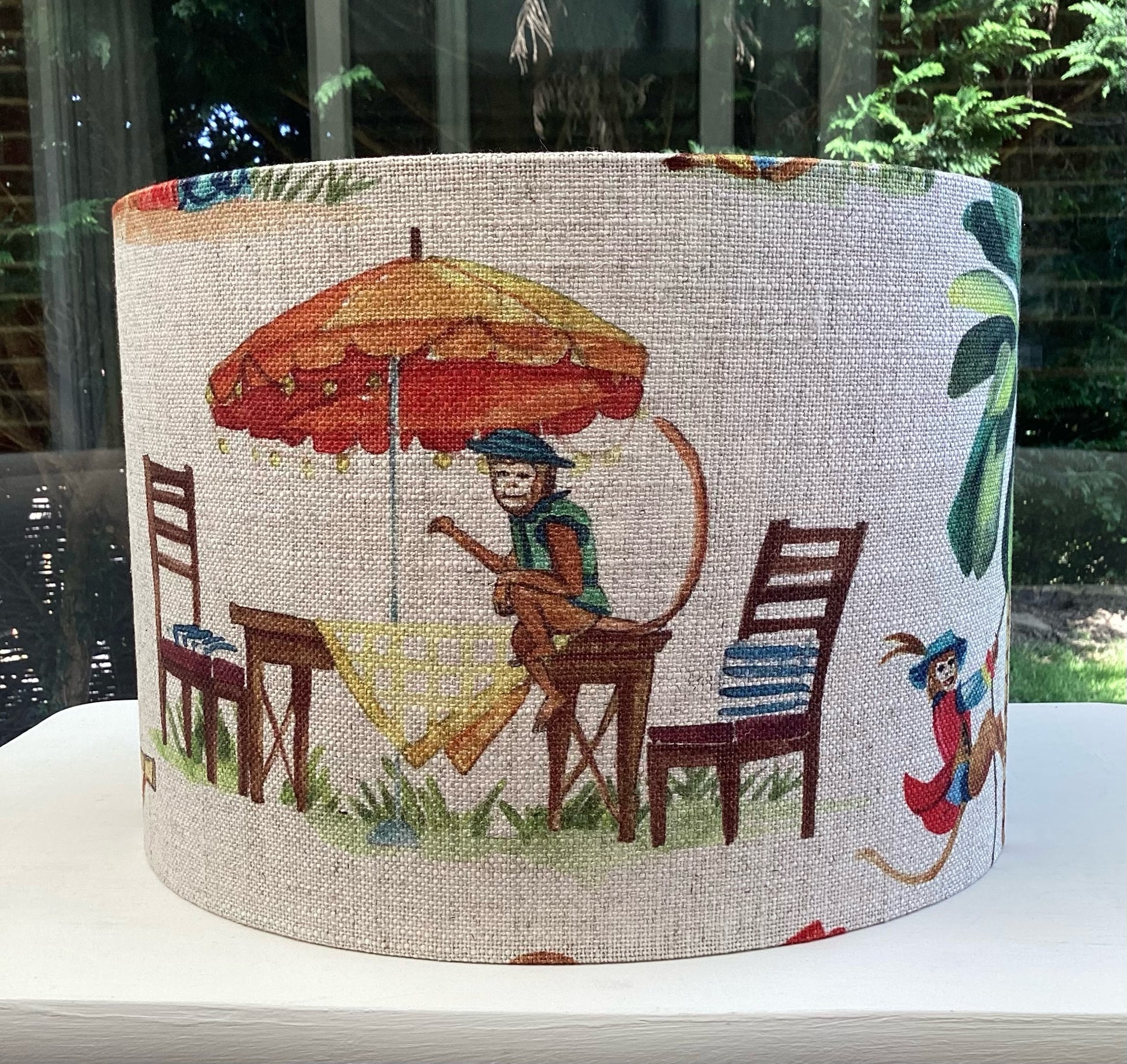 A playful lampshade featuring a cheerful monkey motif, perfect for adding whimsy to any space.
