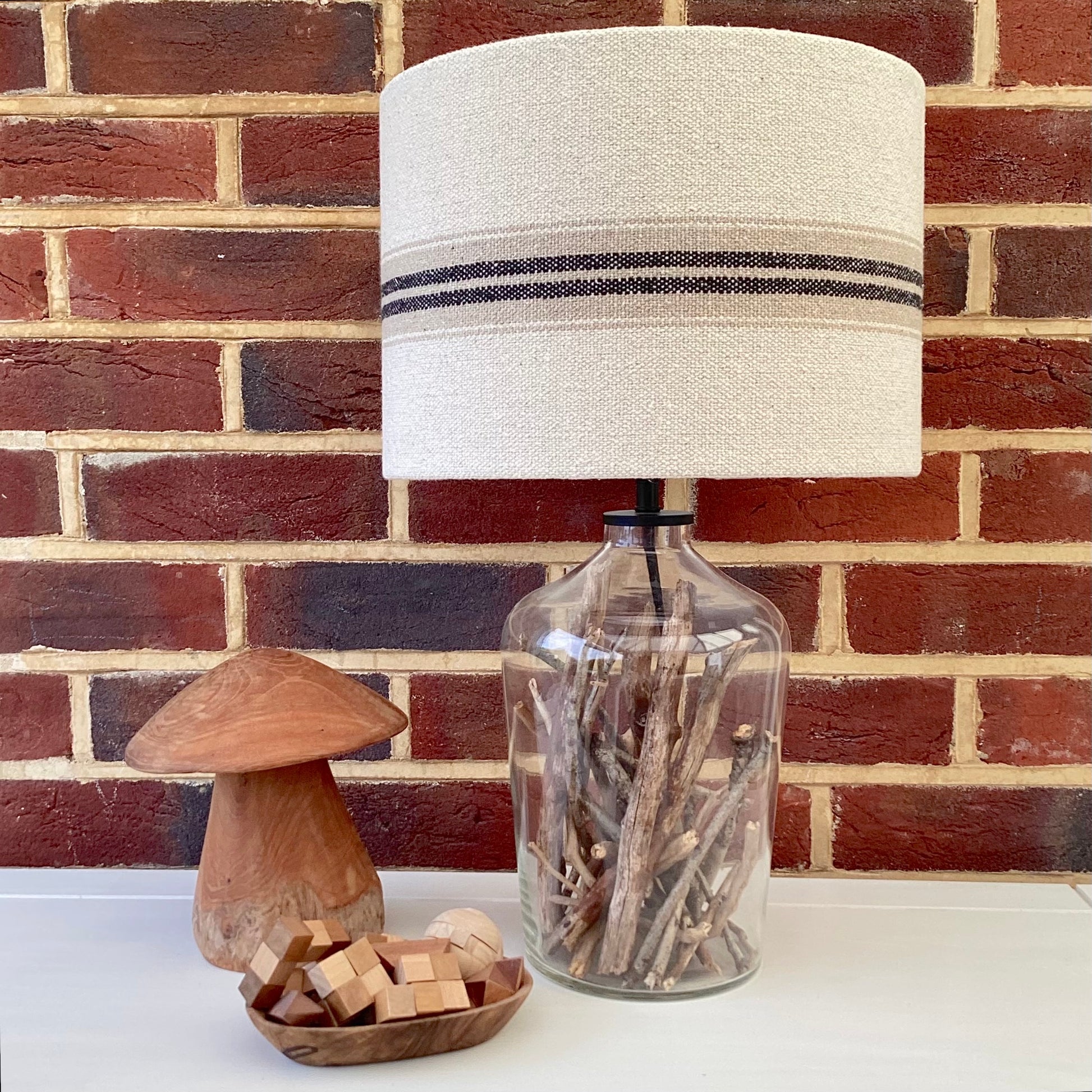 A close-up view of a luxurious, textured lampshade in soft beige, with a delicate geometric design and a subtle sheen, perfect for adding sophistication to any room.