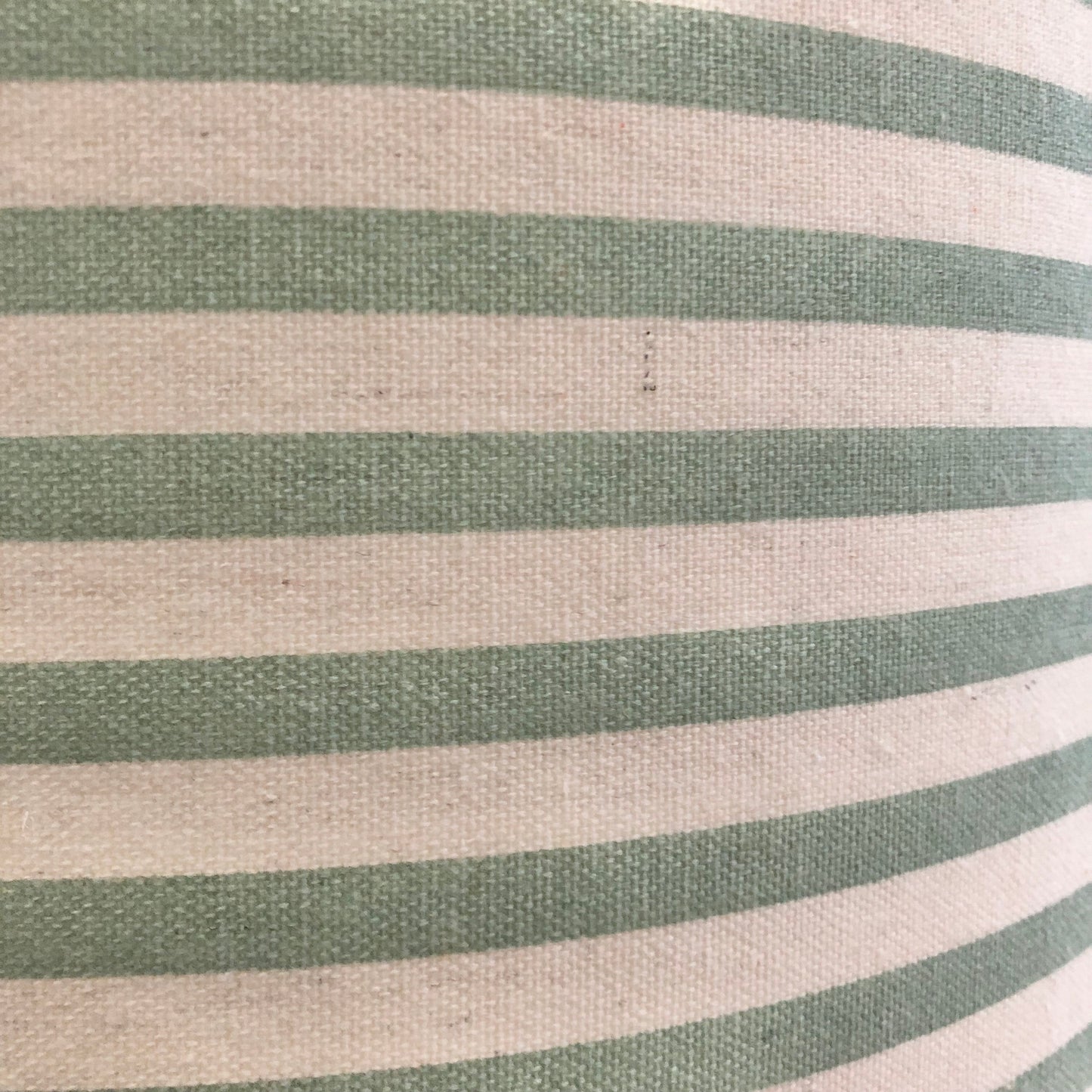 A stylish green striped lampshade with bold, vertical stripes in varying shades of green, offering a modern and vibrant touch to home decor.