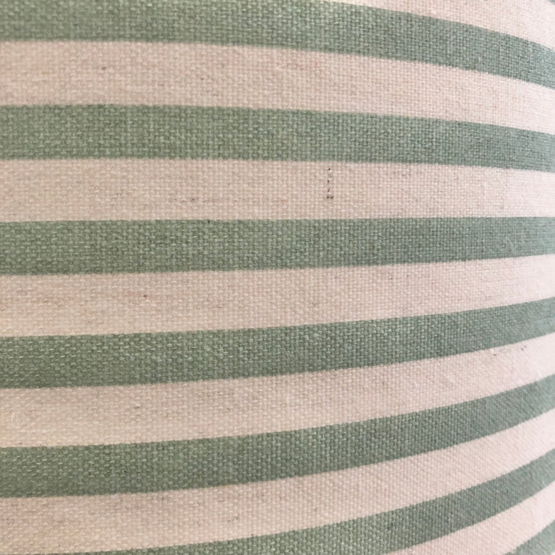 A stylish green striped lampshade with bold, vertical stripes in varying shades of green, offering a modern and vibrant touch to home decor.