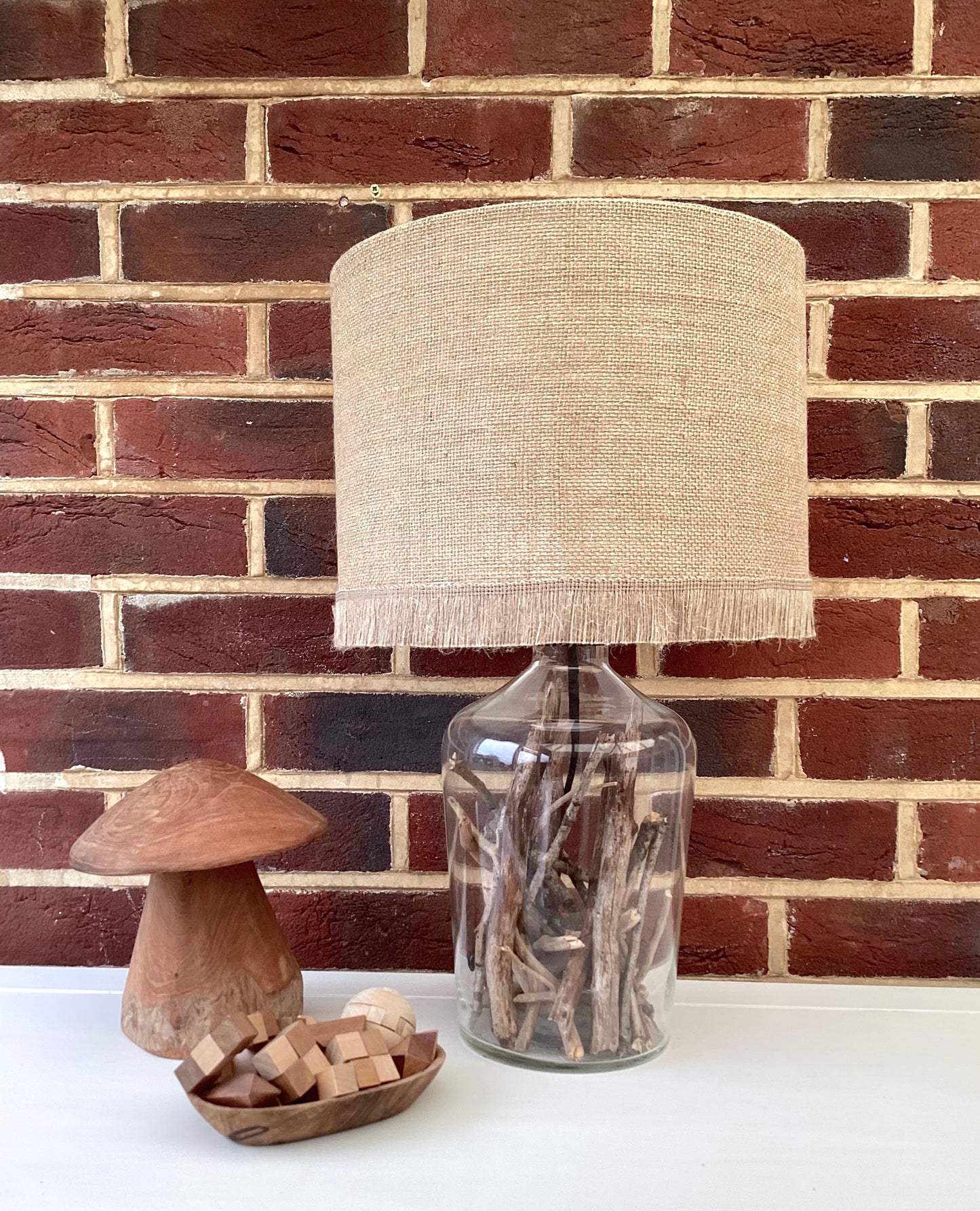 Natural hessian lampshade with a textured weave, offering a rustic and earthy aesthetic, perfect for adding warmth to any room.