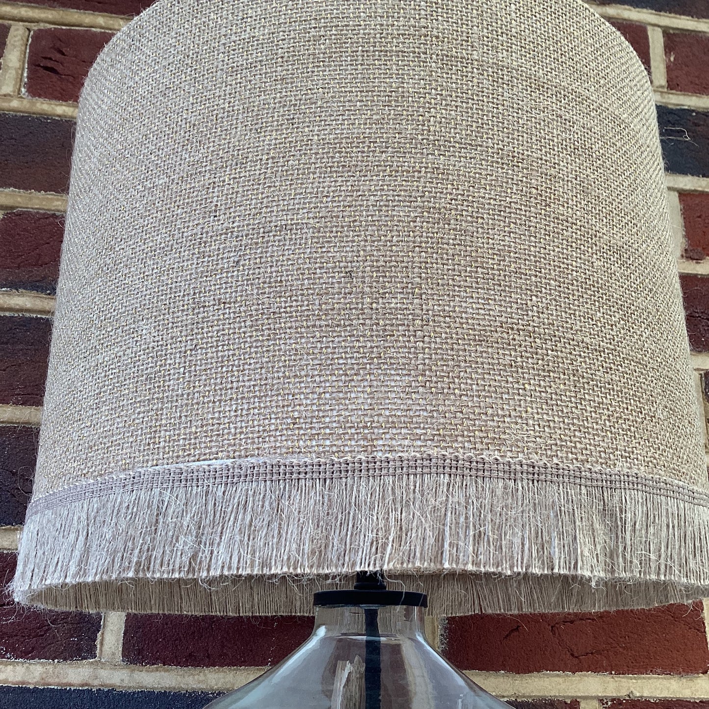 Natural hessian lampshade with a textured weave, offering a rustic and earthy aesthetic, perfect for adding warmth to any room.