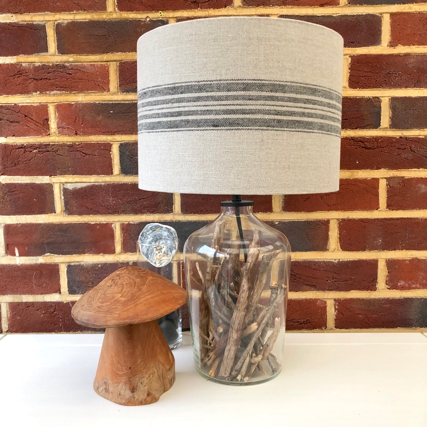 Stylish linen lampshade with black stripes, offering a modern and sophisticated design to complement contemporary home decor.