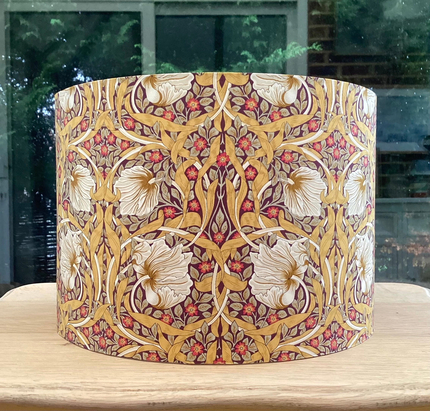 Explore the Pimpernel Aubergine lampshade, a sophisticated blend of rich purple tones and intricate floral patterns. Perfect for adding elegance and charm to your home decor, this handcrafted piece enhances any interior style with timeless beauty.