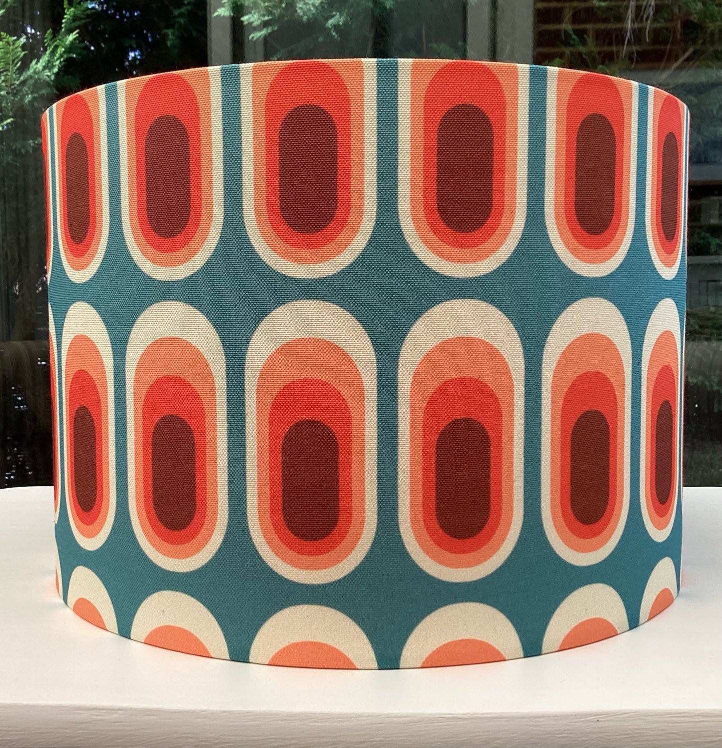 A stylish retro-inspired blue lampshade with vibrant geometric patterns, adding a playful yet sophisticated touch to any room's decor.