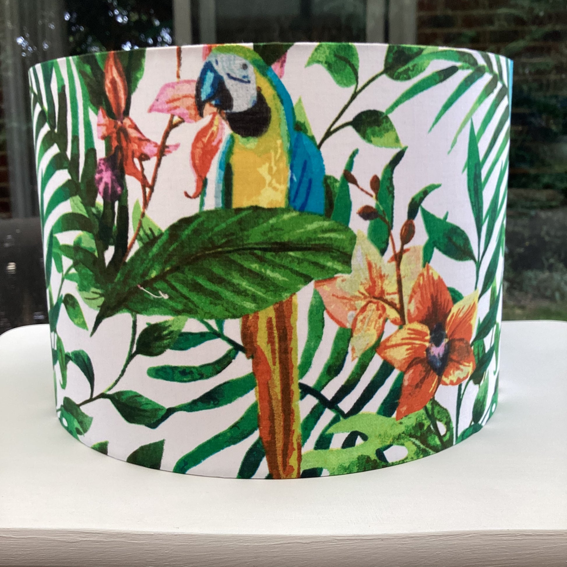 Tropical lampshade with vibrant parrots and green foliage, ideal for adding exotic flair to home decor – handcrafted and unique lighting accessory.