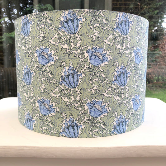 William Morris Anemone lampshade in green and blue, showcasing a classic floral design. Handcrafted with intricate patterns, perfect for adding vintage charm and elegance to any room decor.
