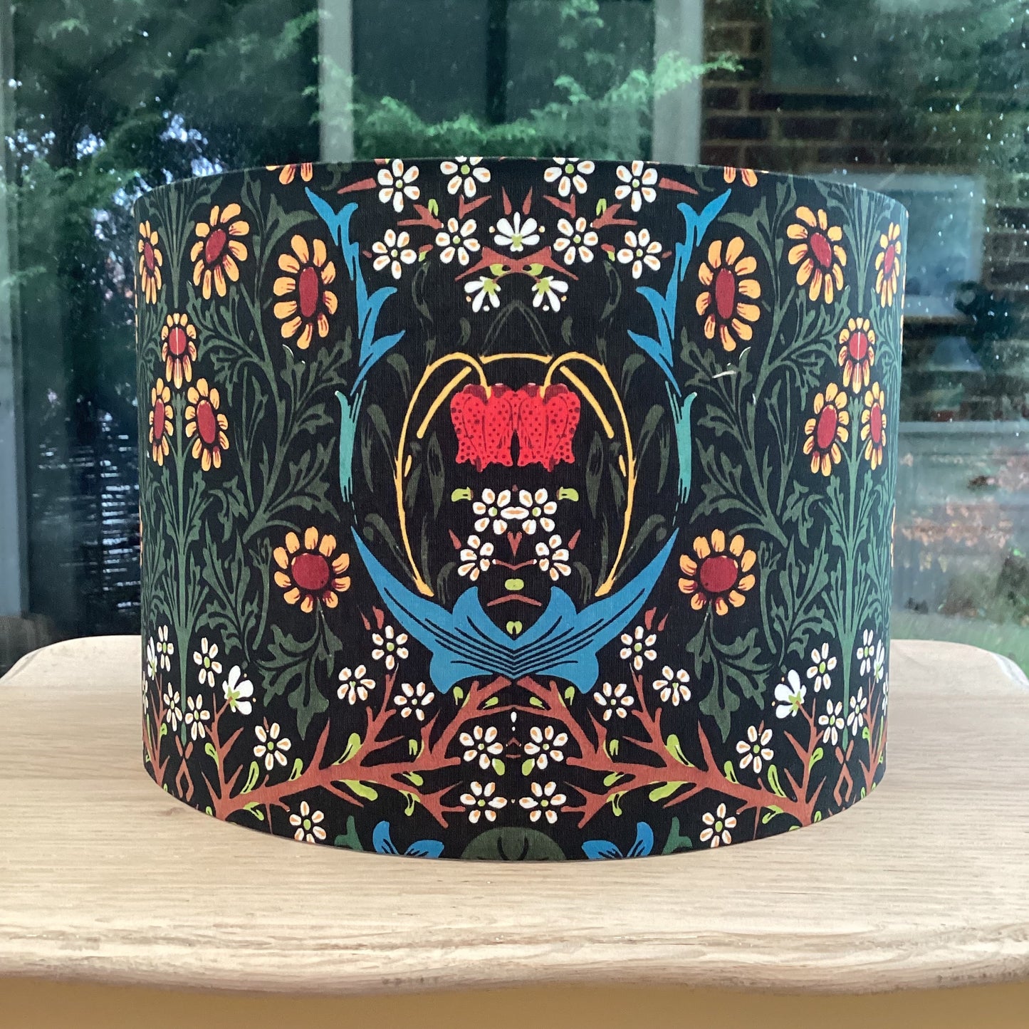 Explore the timeless charm of the William Morris Blackthorn lampshade. Featuring intricate floral and botanical patterns in rich tones, this handcrafted lampshade adds elegance to any space. Perfect for vintage and classic decor enthusiasts.