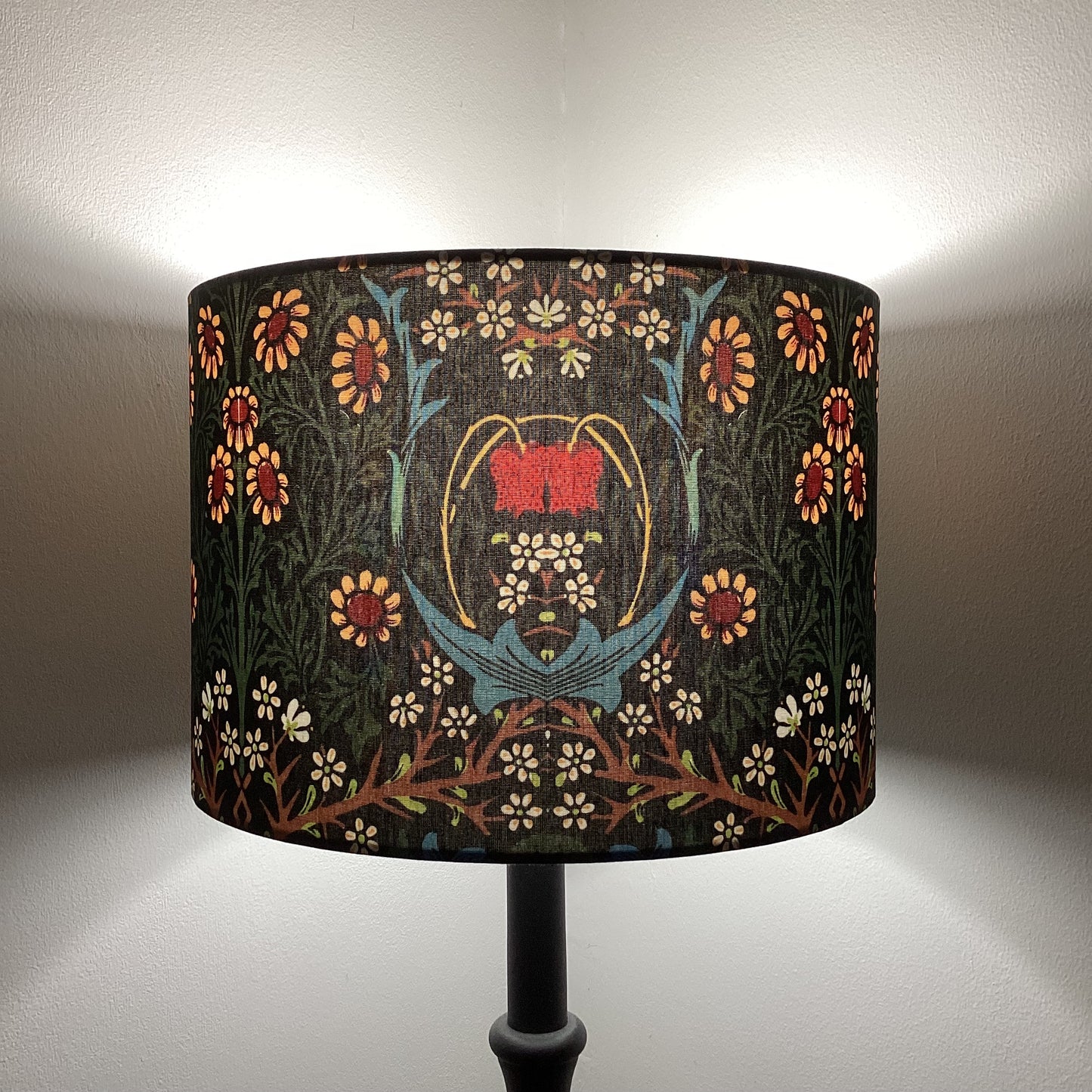 Explore the timeless charm of the William Morris Blackthorn lampshade. Featuring intricate floral and botanical patterns in rich tones, this handcrafted lampshade adds elegance to any space. Perfect for vintage and classic decor enthusiasts.