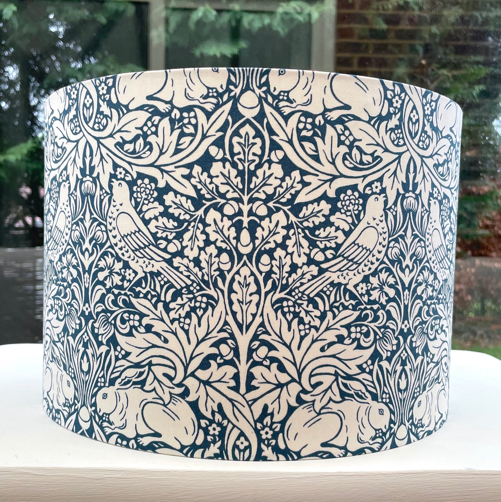 William Morris Brer Rabbit lampshade in navy blue with detailed floral and animal motifs, perfect for adding a vintage, artistic touch to any room.