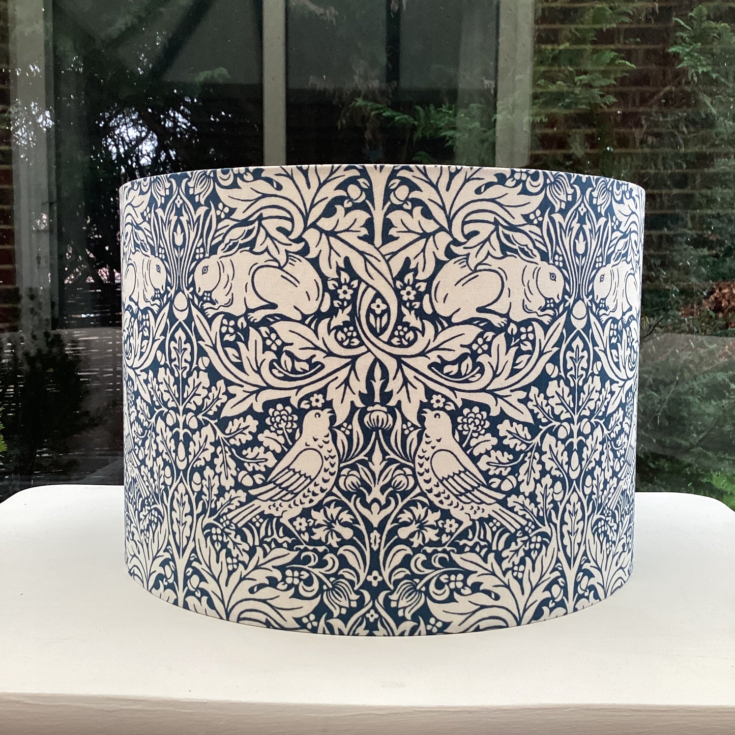 William Morris Brer Rabbit lampshade in navy blue with detailed floral and animal motifs, perfect for adding a vintage, artistic touch to any room.