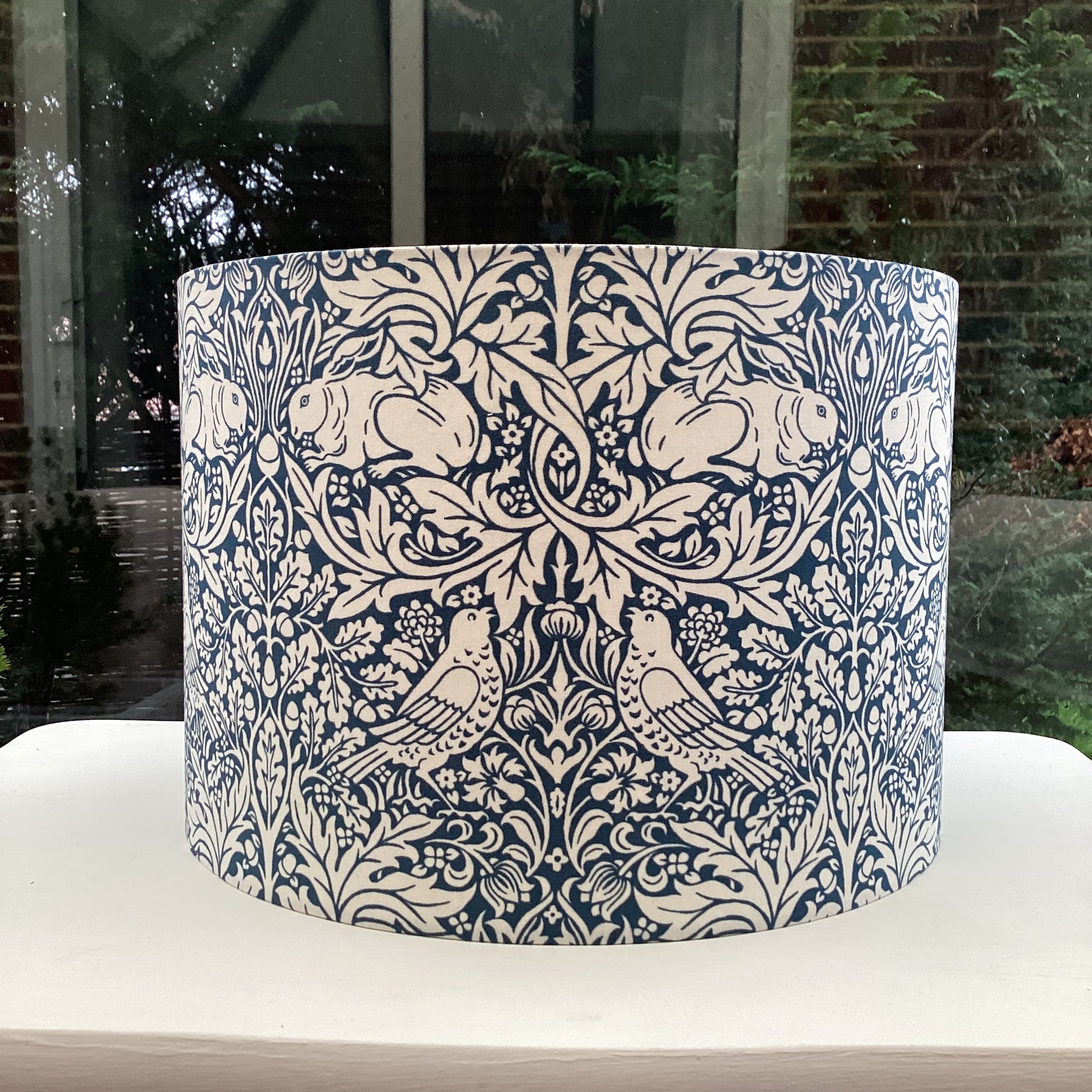 William Morris Brer Rabbit lampshade in navy blue with detailed floral and animal motifs, perfect for adding a vintage, artistic touch to any room.