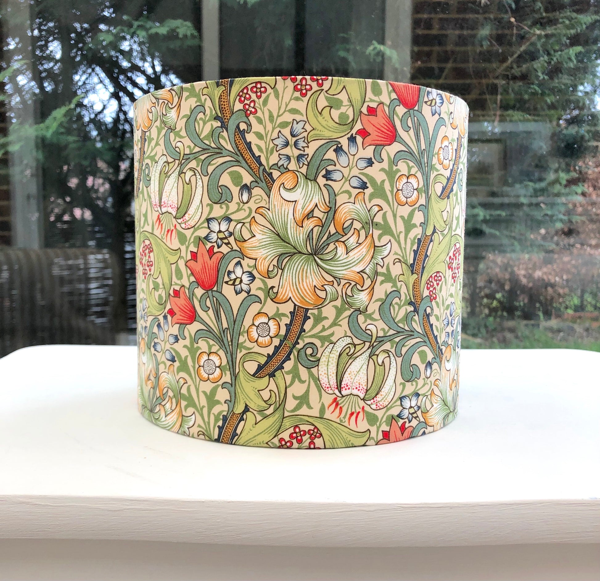 William Morris Golden Lily lampshade featuring a rich, vintage floral design with golden hues, perfect for adding a touch of classic elegance to any room decor.