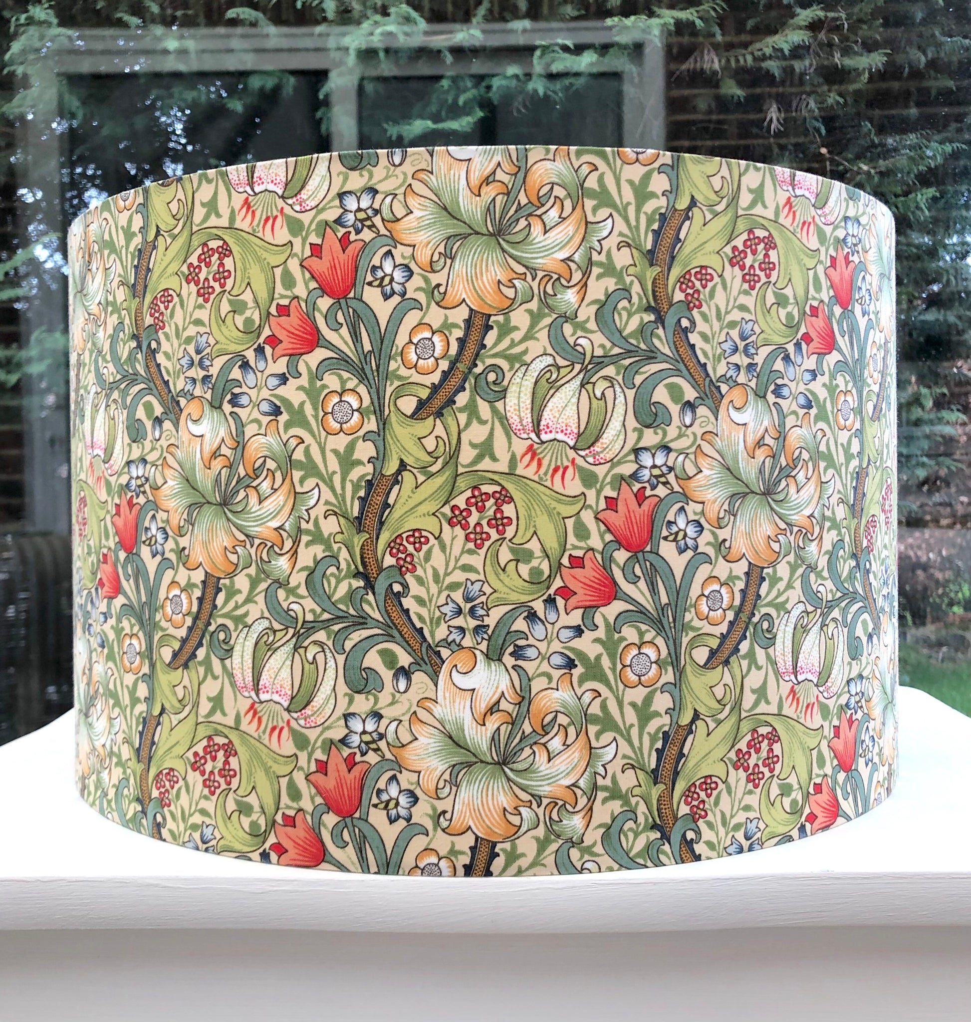 William Morris Golden Lily lampshade featuring a rich, vintage floral design with golden hues, perfect for adding a touch of classic elegance to any room decor.