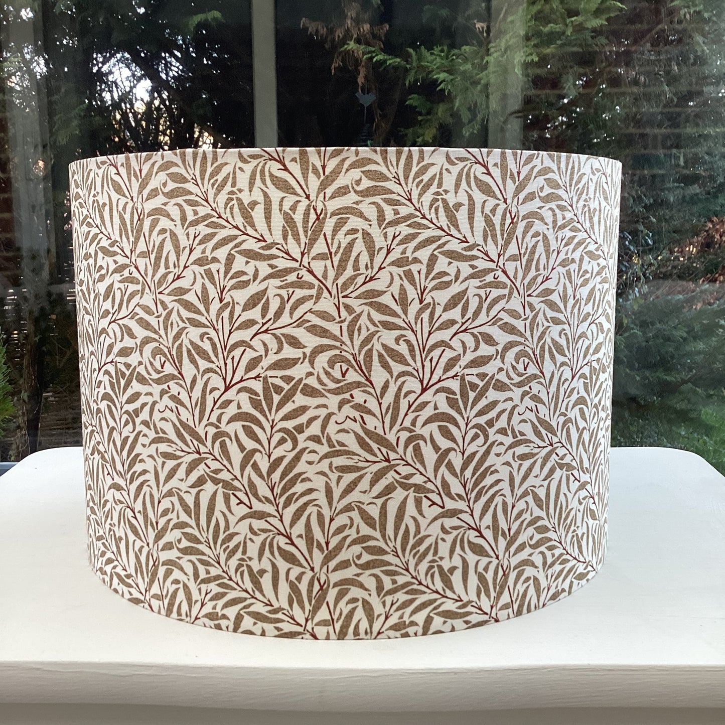 Cream gold coloured lampshade featuring a delicate willow bough pattern, offering a serene and nature-inspired ambiance.