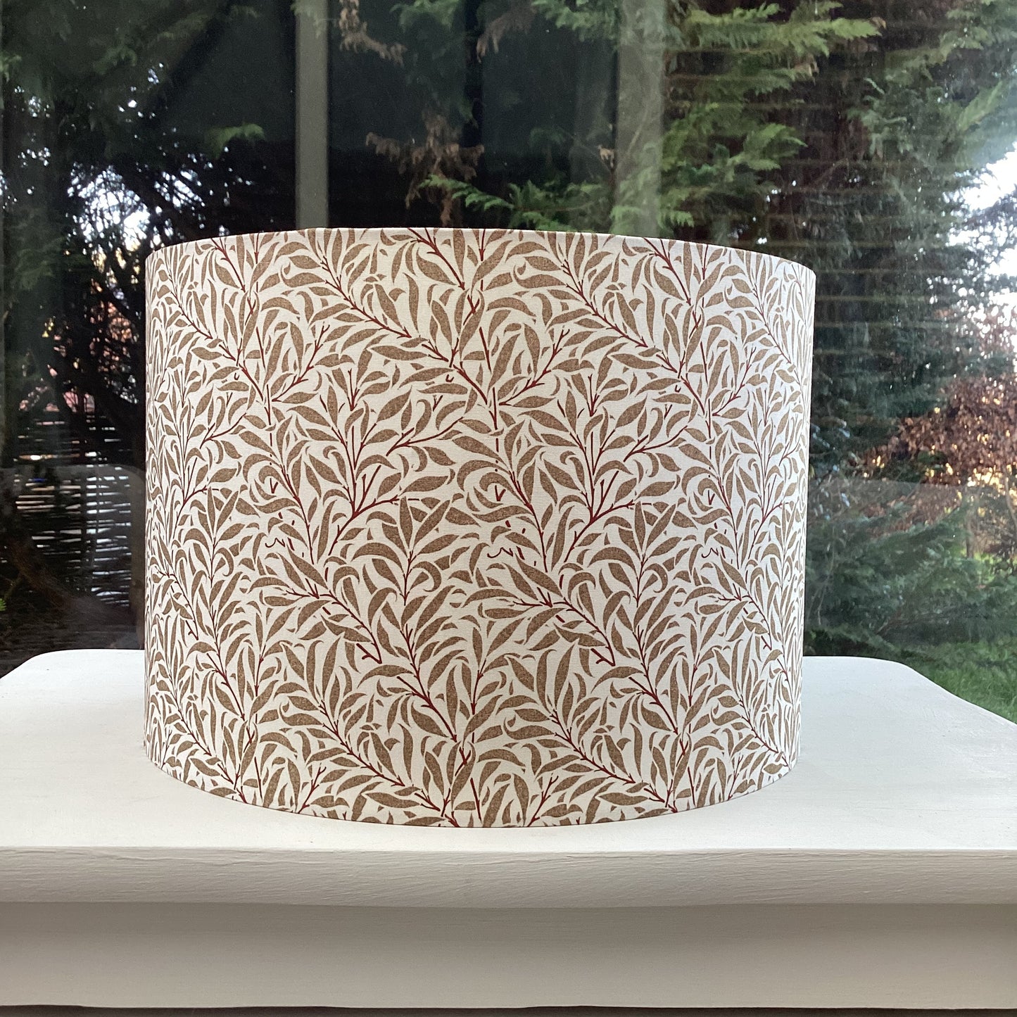 Cream gold coloured lampshade featuring a delicate willow bough pattern, offering a serene and nature-inspired ambiance.