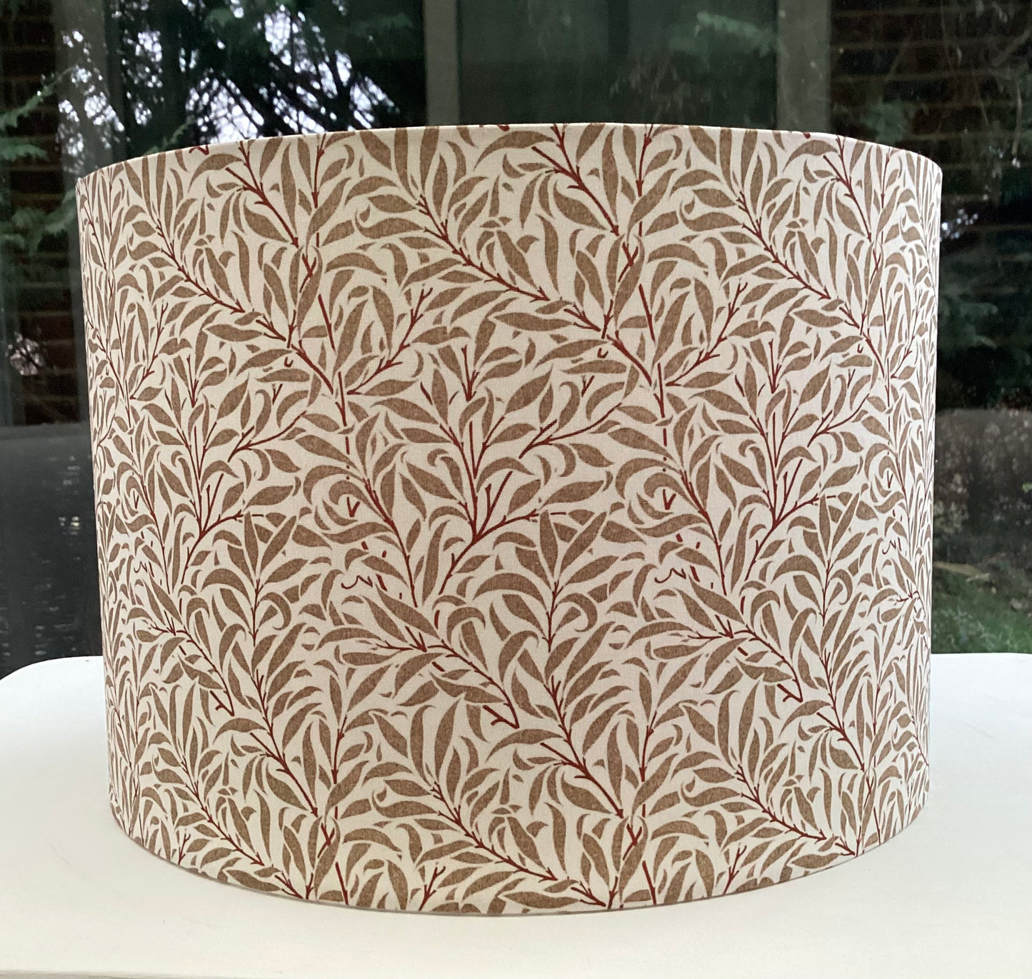 Cream gold coloured lampshade featuring a delicate willow bough pattern, offering a serene and nature-inspired ambiance.