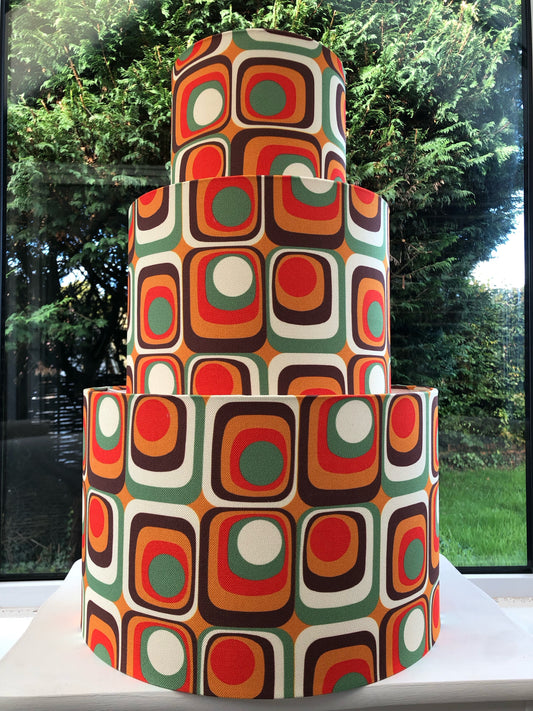 Colorful retro-inspired lampshade with bold geometric patterns, reminiscent of 1960s design aesthetics.