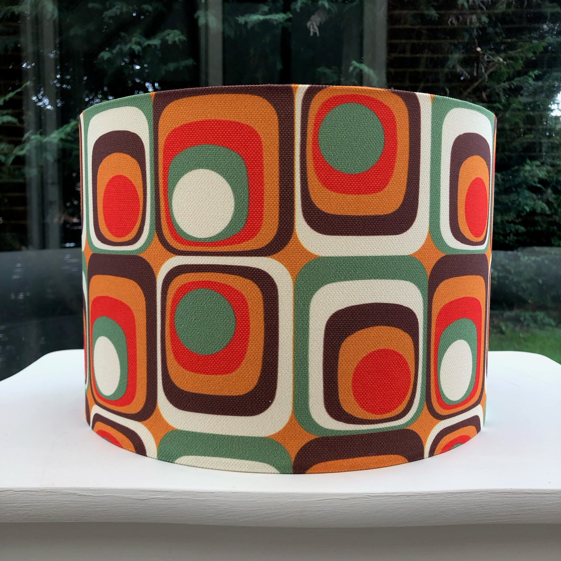 Colorful retro-inspired lampshade with bold geometric patterns, reminiscent of 1960s design aesthetics.