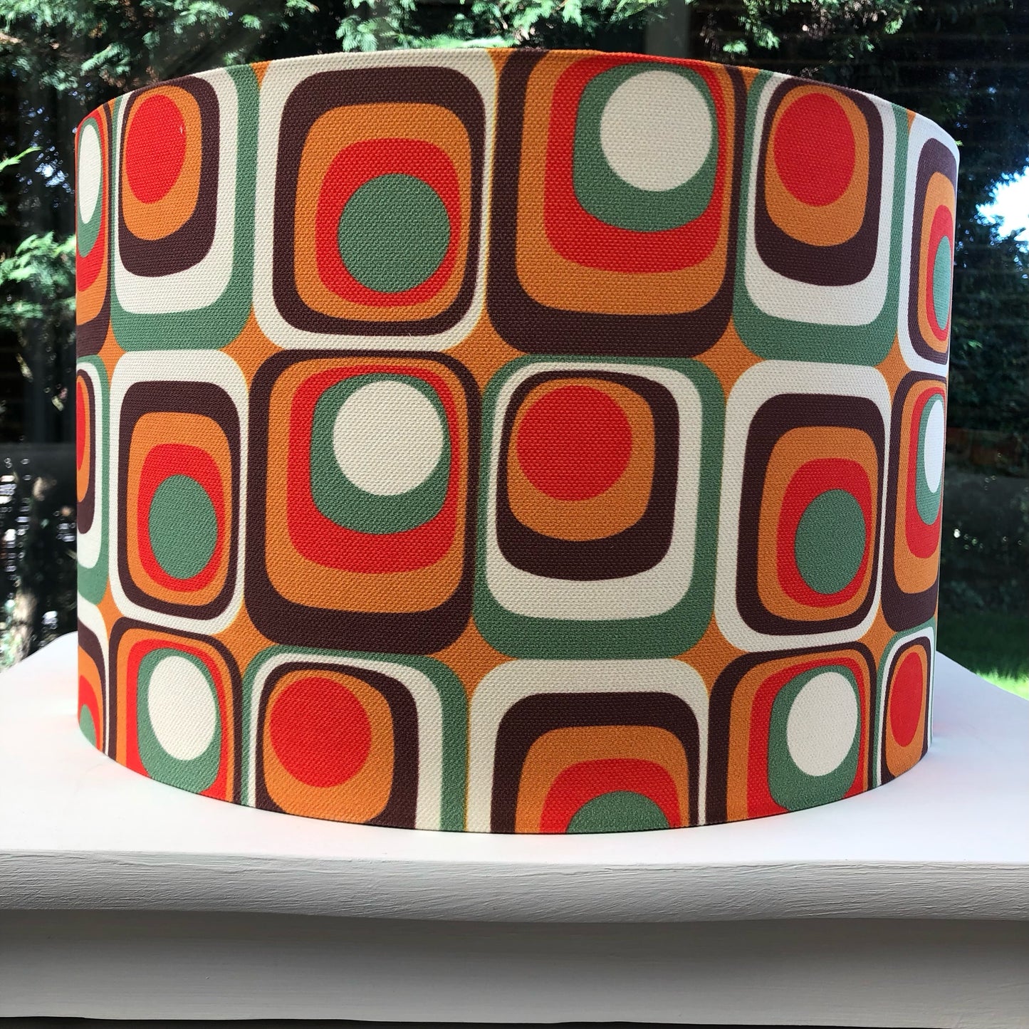 Colorful retro-inspired lampshade with bold geometric patterns, reminiscent of 1960s design aesthetics.