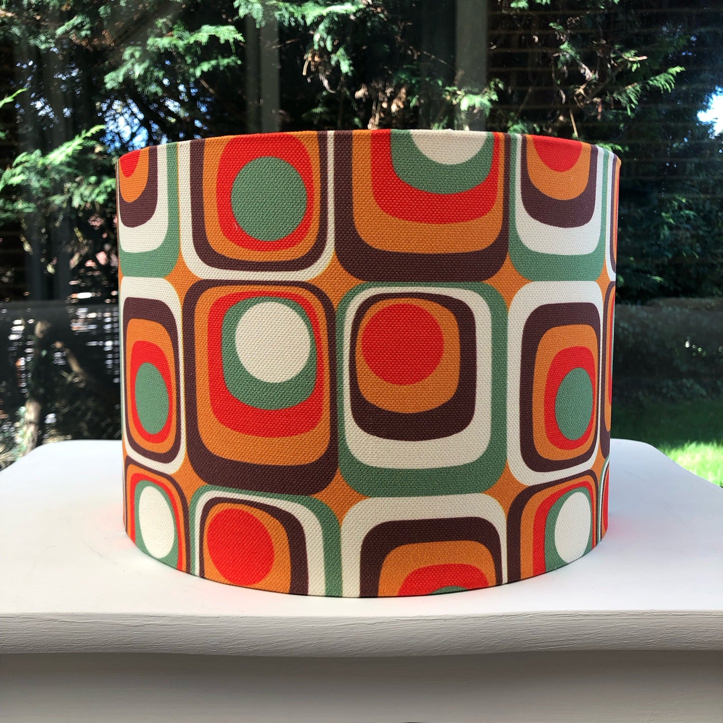 Colorful retro-inspired lampshade with bold geometric patterns, reminiscent of 1960s design aesthetics.