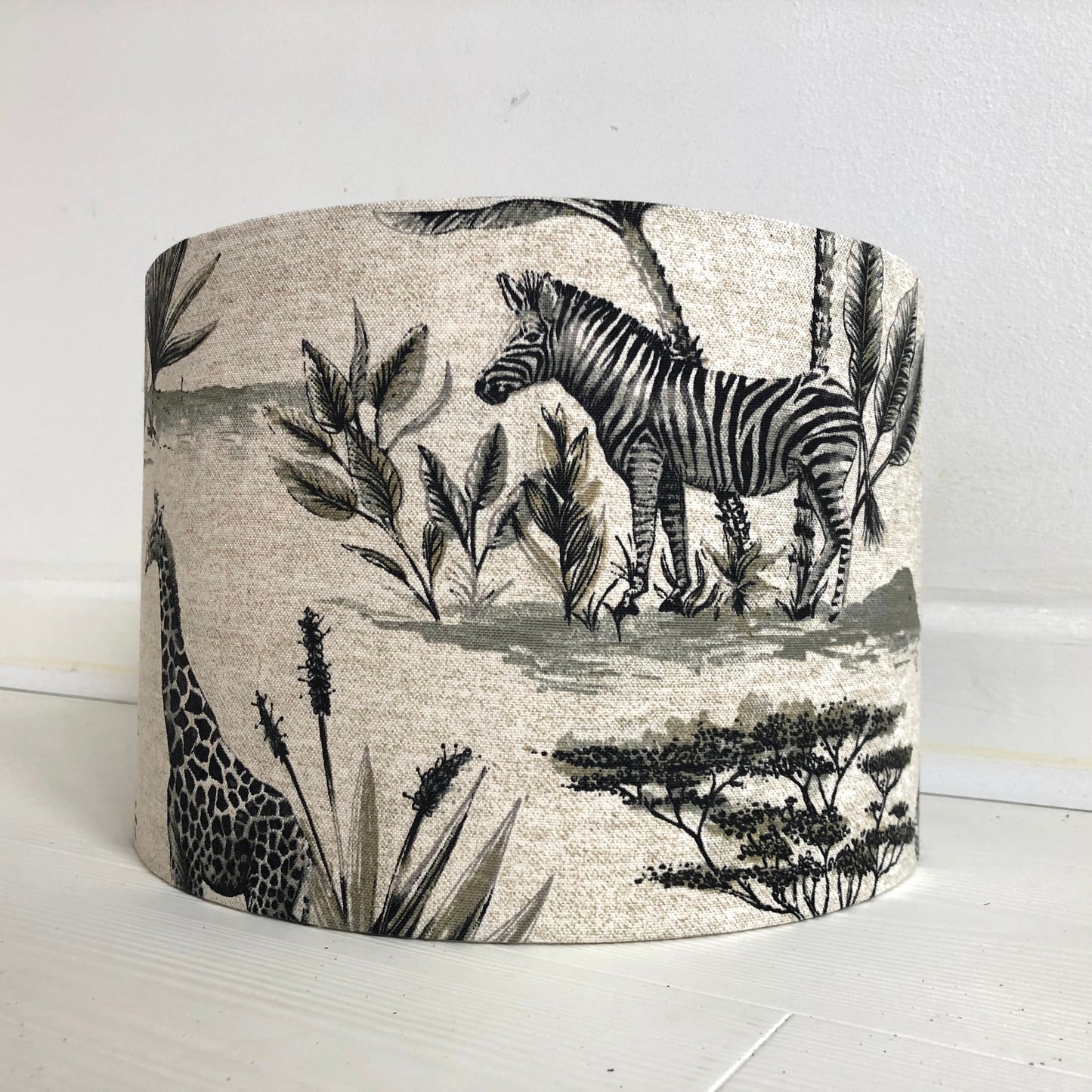 African safari-themed lampshade with vibrant animal and landscape motifs, perfect for adding a touch of exotic style and warmth to home decor.