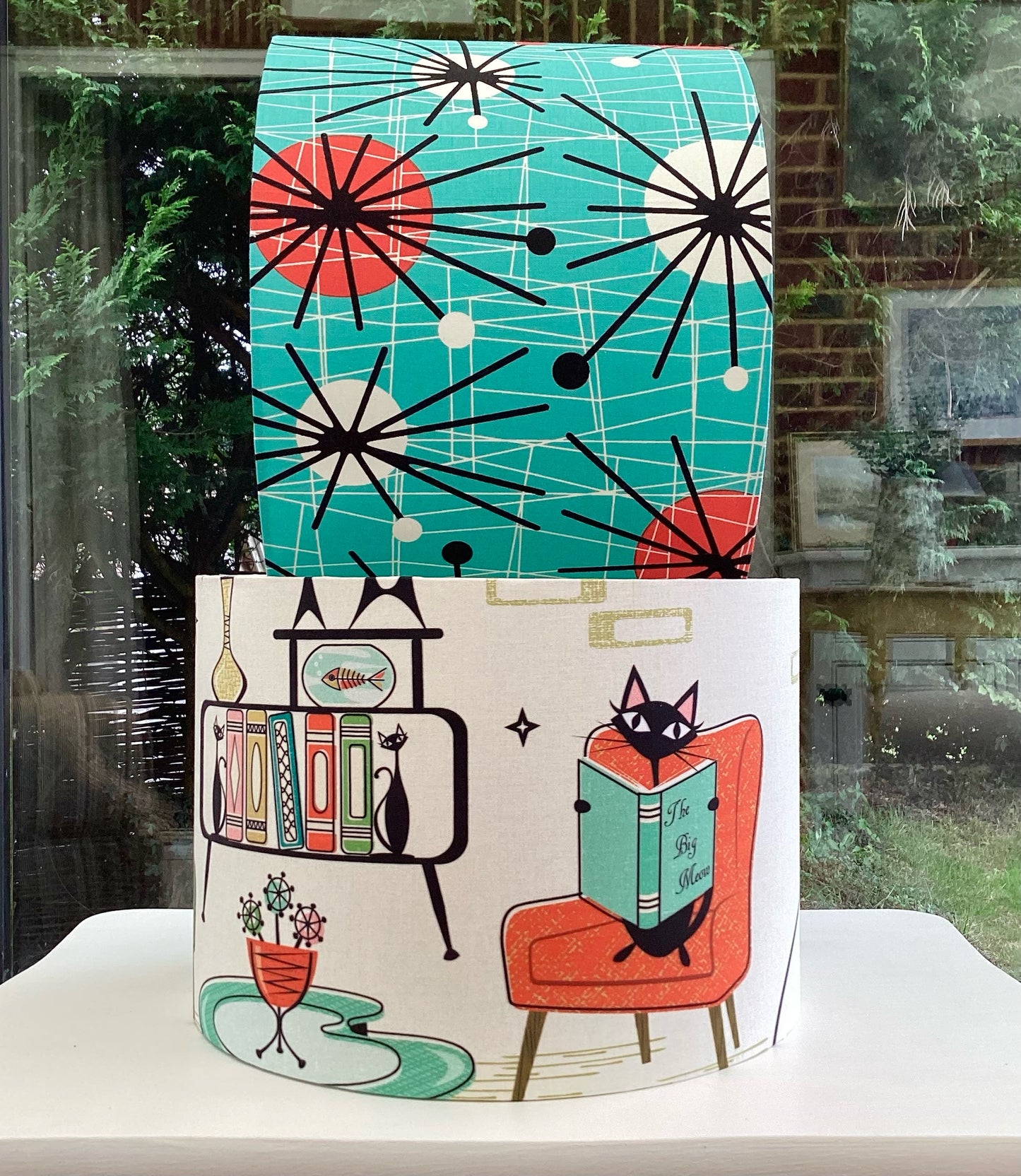 A stylish lampshade with a bold atomic kitten print, featuring vibrant colors and a playful design, perfect for adding a unique touch to modern decor.