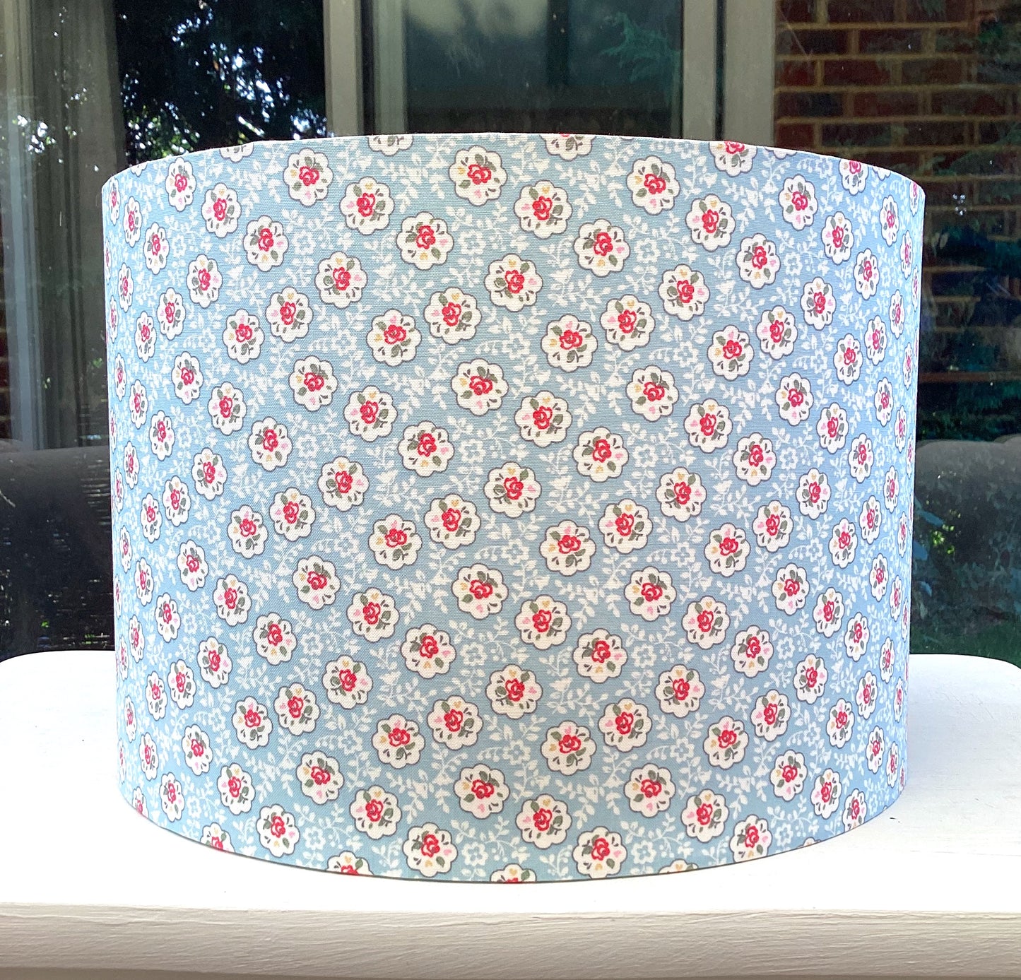 Blue Provence Rose lampshade with a soft, floral design in shades of blue and white, adding a touch of elegance and charm to any room.