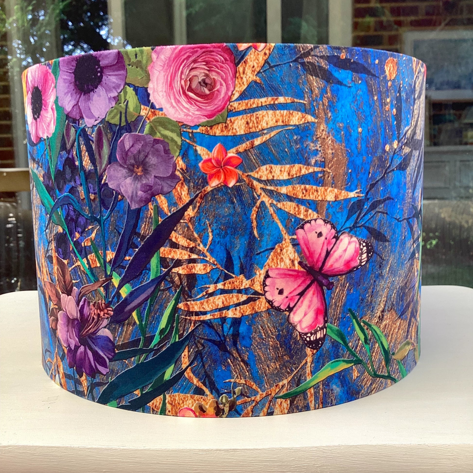 A luxurious blue velvet lampshade with a soft, plush texture and a warm, inviting glow, adding a touch of sophistication to any room.