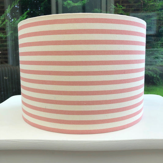 Stylish pink striped lampshade with soft hues of blush and white, offering a modern and chic design to complement any room decor.