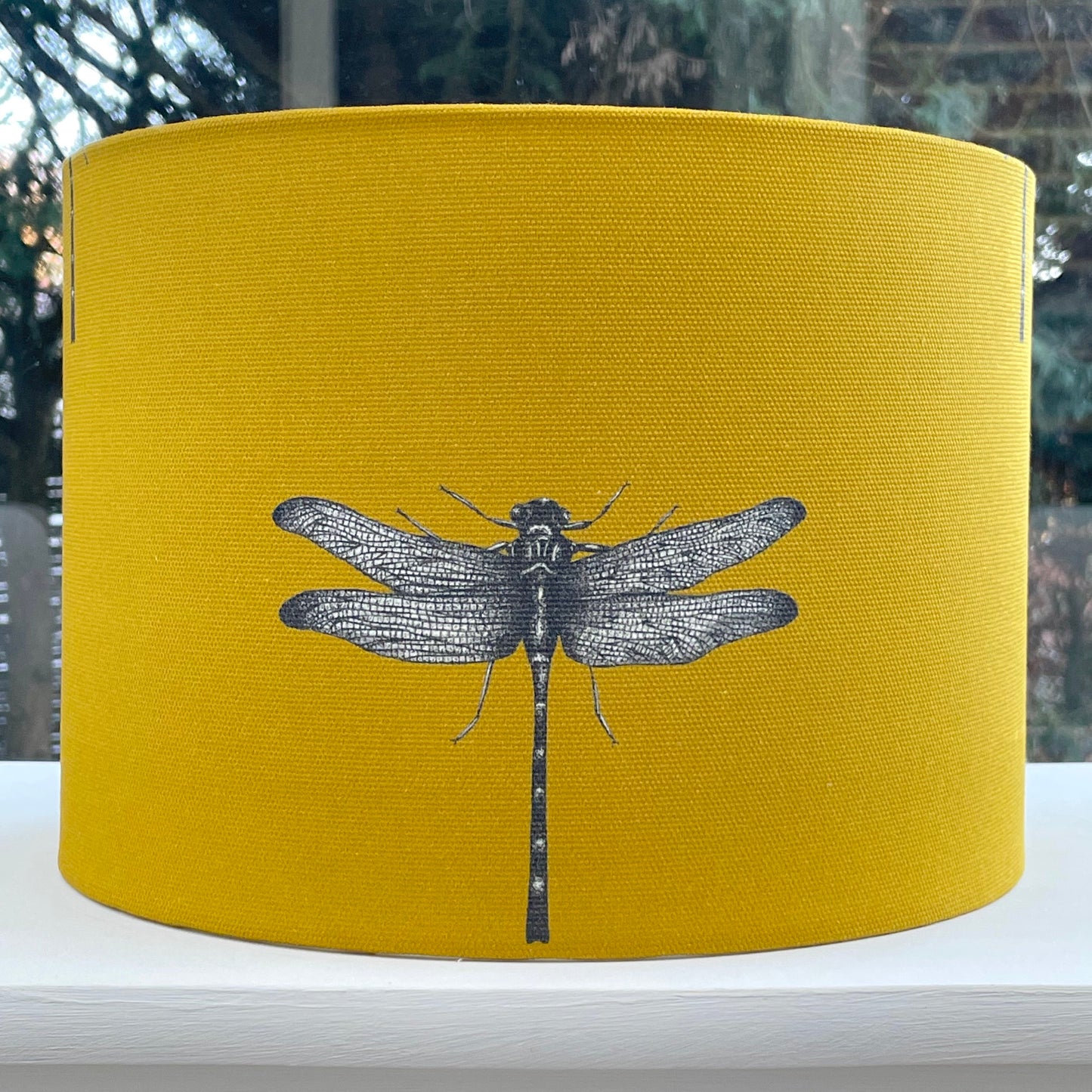 Delicate dragonfly design on a mustard ochre coloured background, adding a whimsical touch to any room.