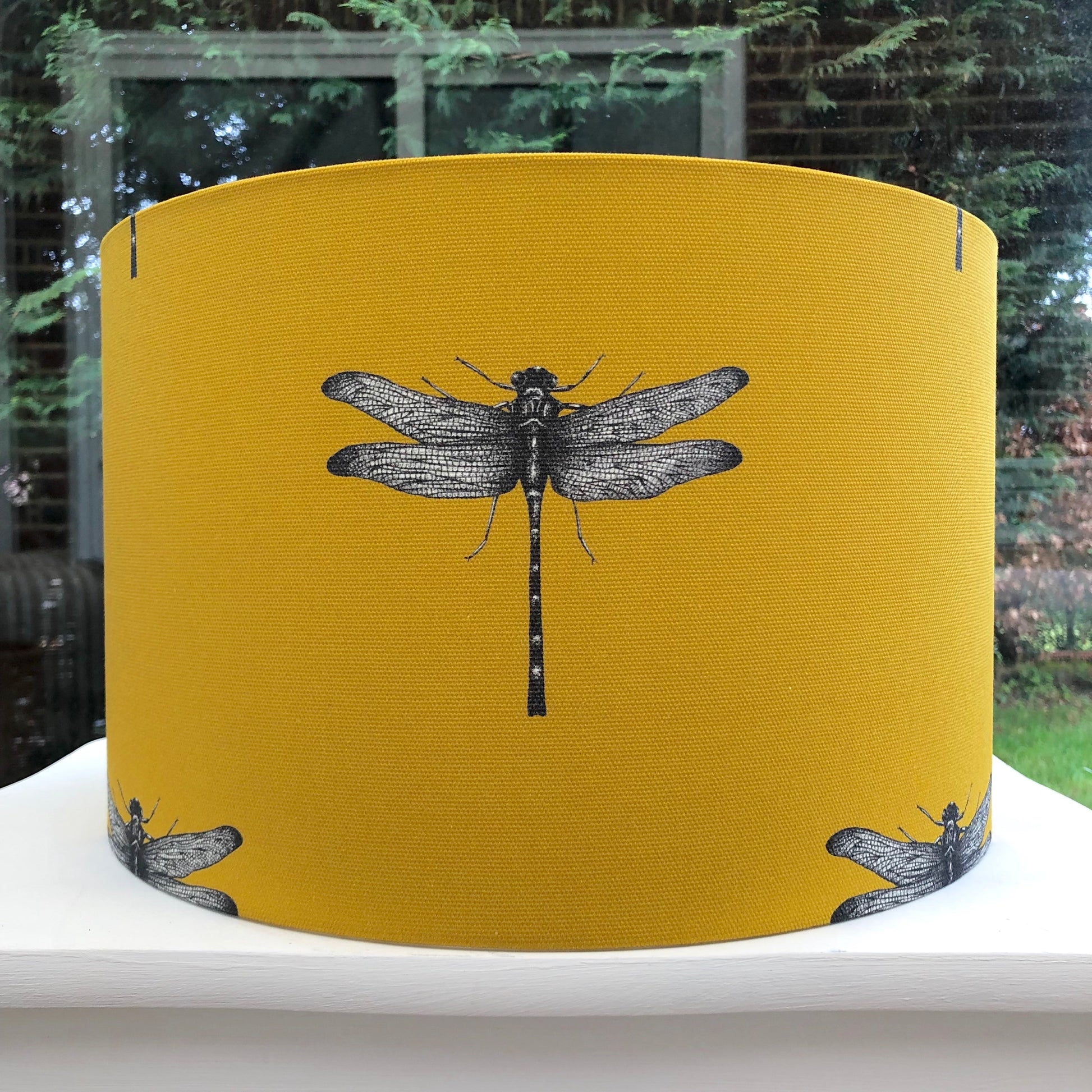 Delicate dragonfly design on a mustard ochre coloured background, adding a whimsical touch to any room.