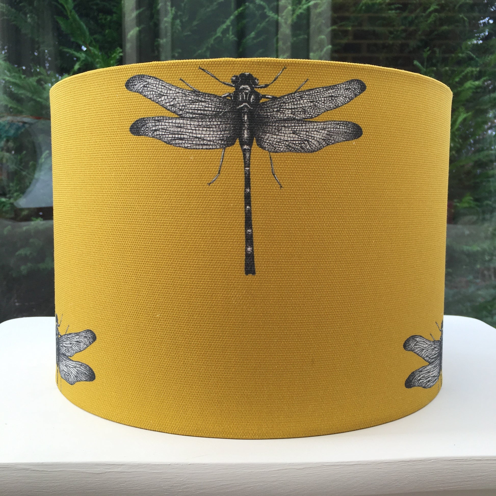 Delicate dragonfly design on a mustard ochre coloured background, adding a whimsical touch to any room.