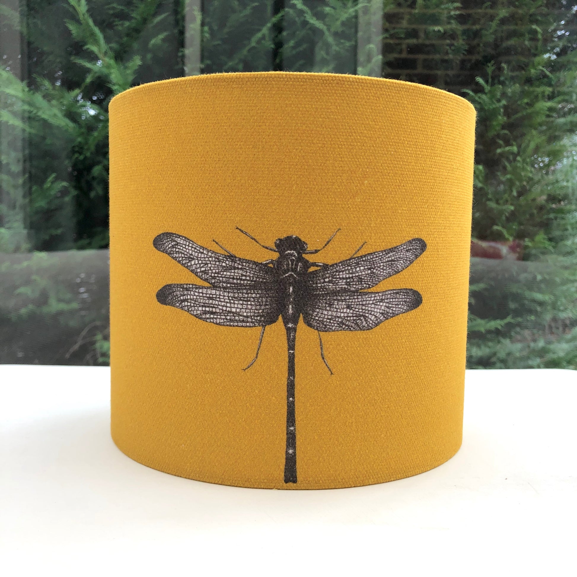 Delicate dragonfly design on a mustard ochre coloured background, adding a whimsical touch to any room.