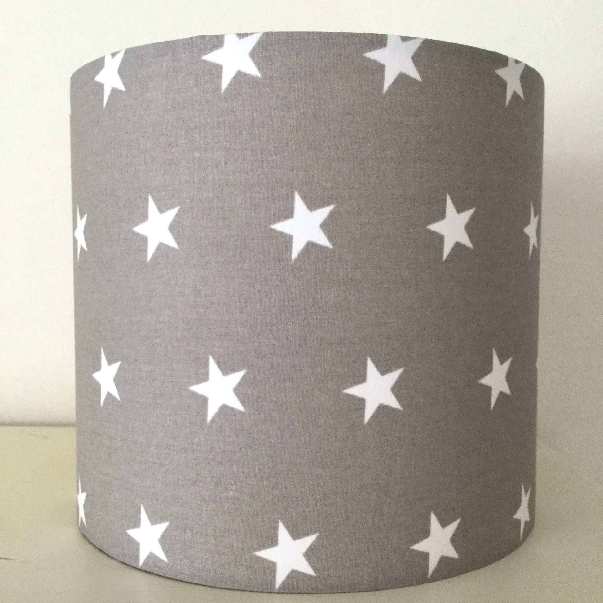 Modern grey lampshade with stars motif, adding contemporary flair to any space.