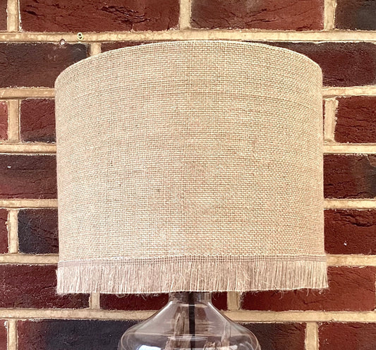 Natural hessian lampshade with a textured weave, offering a rustic and earthy aesthetic, perfect for adding warmth to any room.