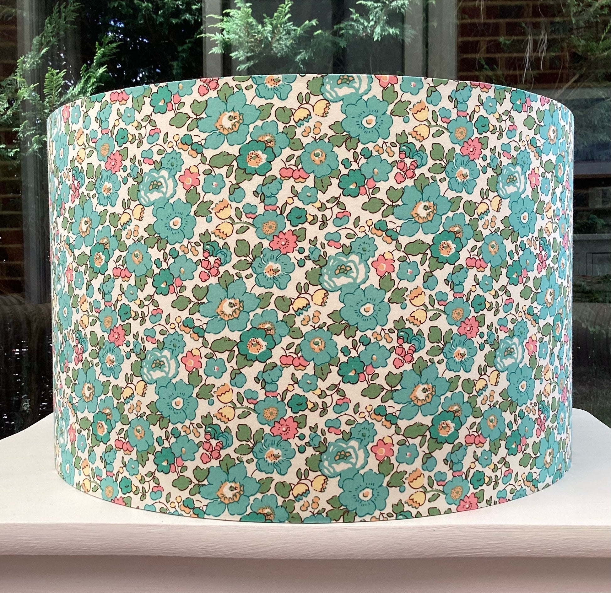 Stylish lampshade in vibrant green and pink floral Liberty Betsy fabric, adding a fresh and lively touch to home decor.