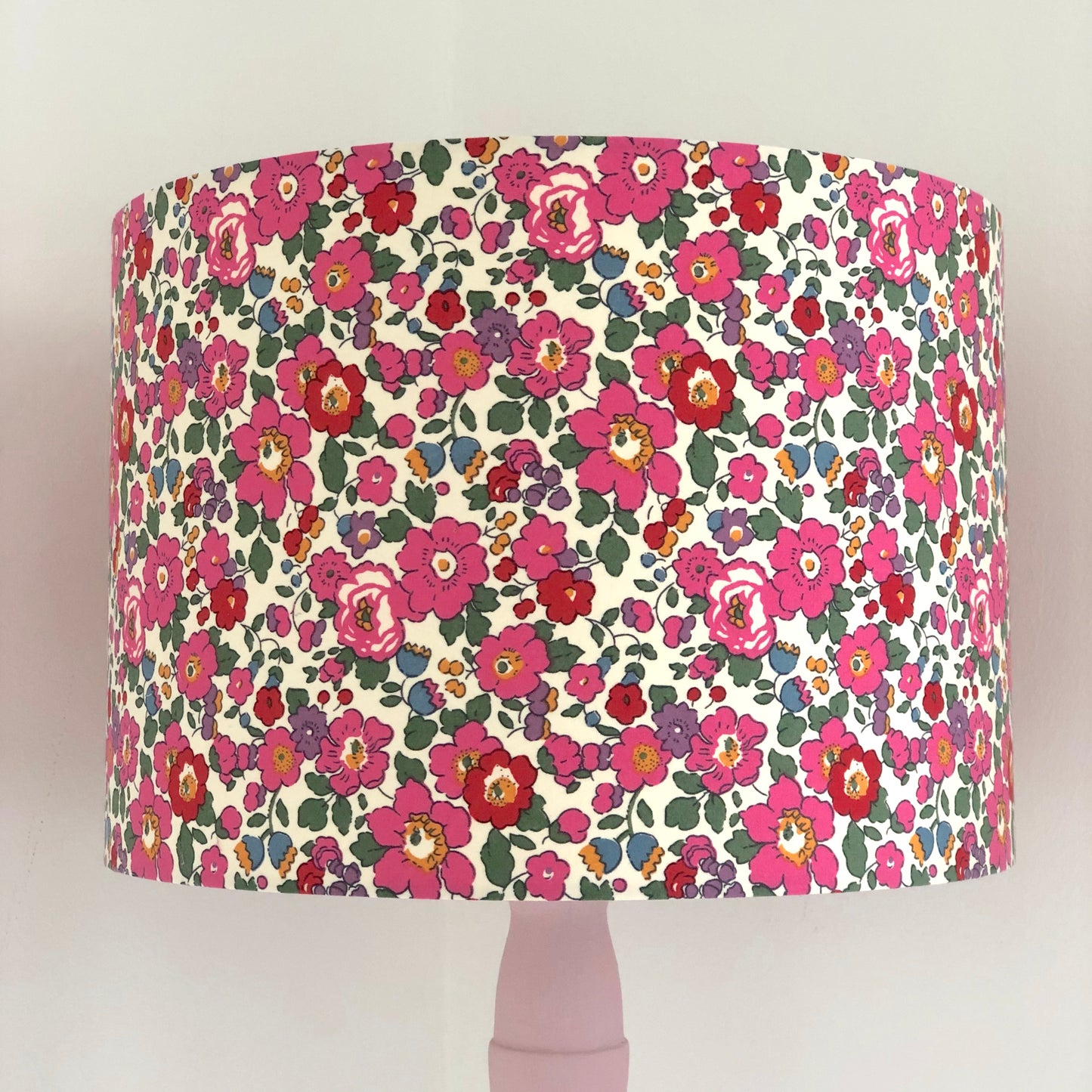 A vibrant floral lampshade in red, pink, and green Liberty Betsy pattern, bringing a lively and stylish touch to any room.