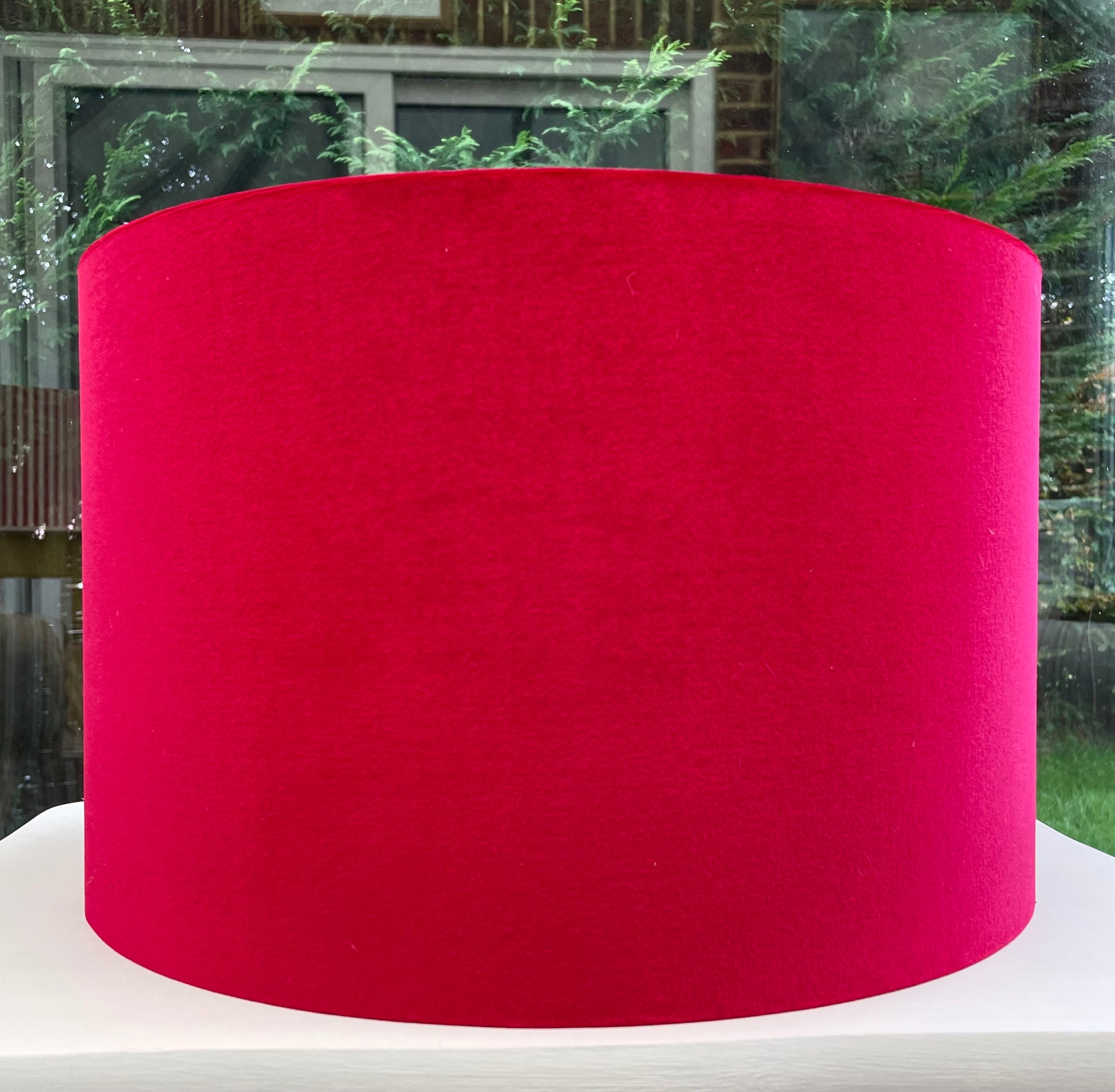 Luxurious red velvet lampshade with rich texture and a sophisticated design, perfect for adding elegance and warmth to home decor.