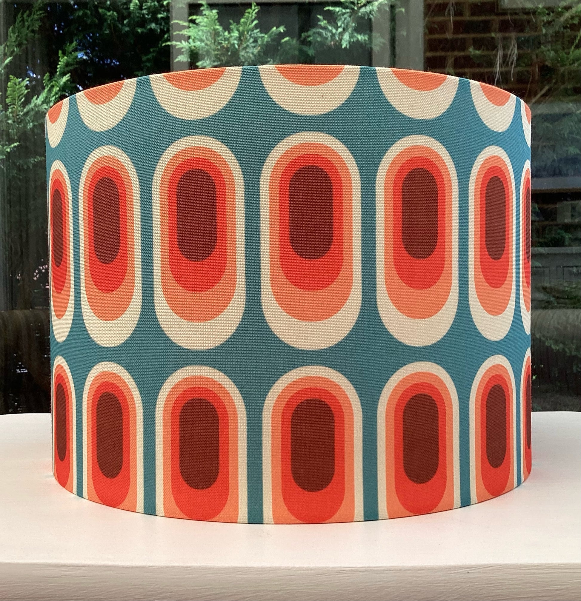 A stylish retro-inspired blue lampshade with vibrant geometric patterns, adding a playful yet sophisticated touch to any room's decor.