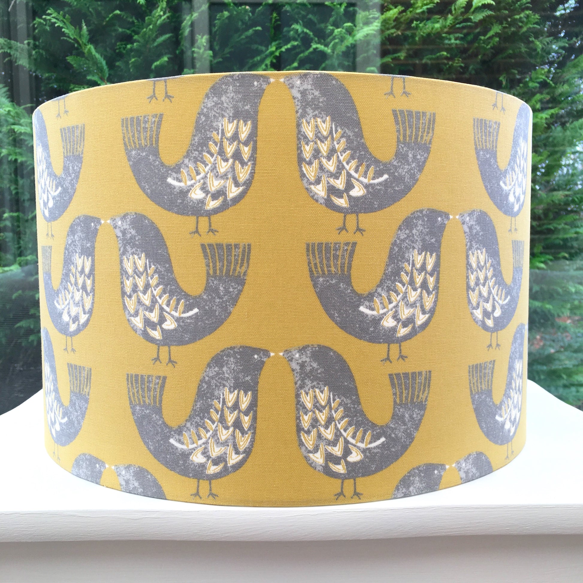 Scandinavian-inspired lampshade featuring a charming bird pattern against a soft pastel background.