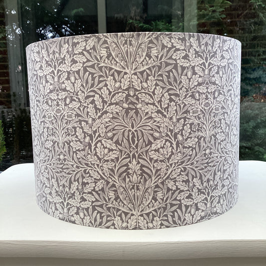 Gray lampshade featuring an artistic acorn pattern, adding a touch of nature-inspired charm to any space.