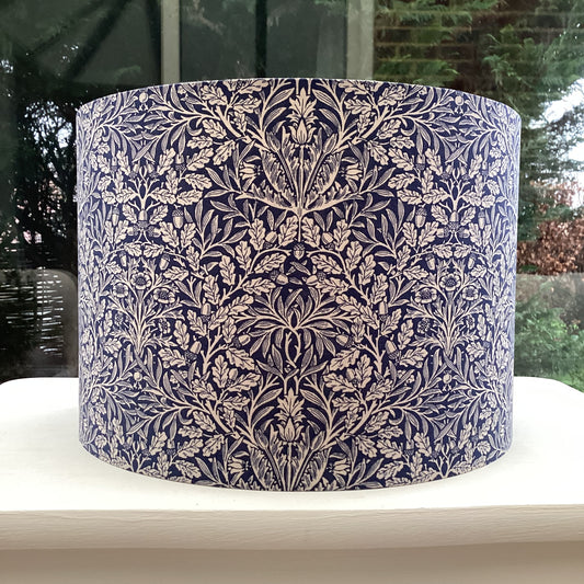 Navy blue lampshade featuring an artistic acorn pattern, adding a touch of nature-inspired charm to any space.