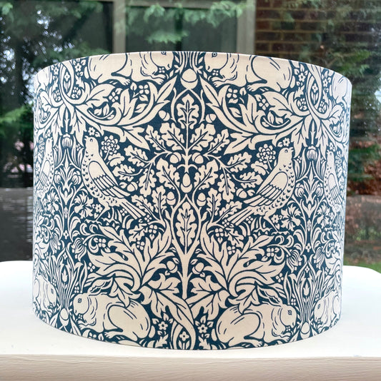 Vibrant blue lampshade with a classic brocade pattern, perfect for adding a pop of color to any space.