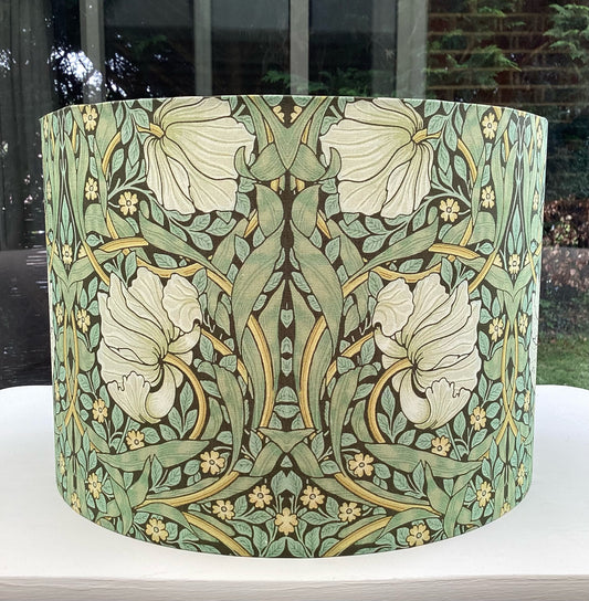 Green lampshade featuring a floral pattern, adding a touch of nature-inspired charm to any space.